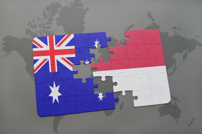 puzzle with the national flag of australia and indonesia on a world map background.3D illustration