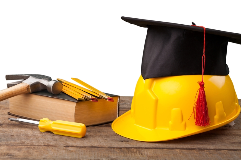 Construction tools and a graduate hat.