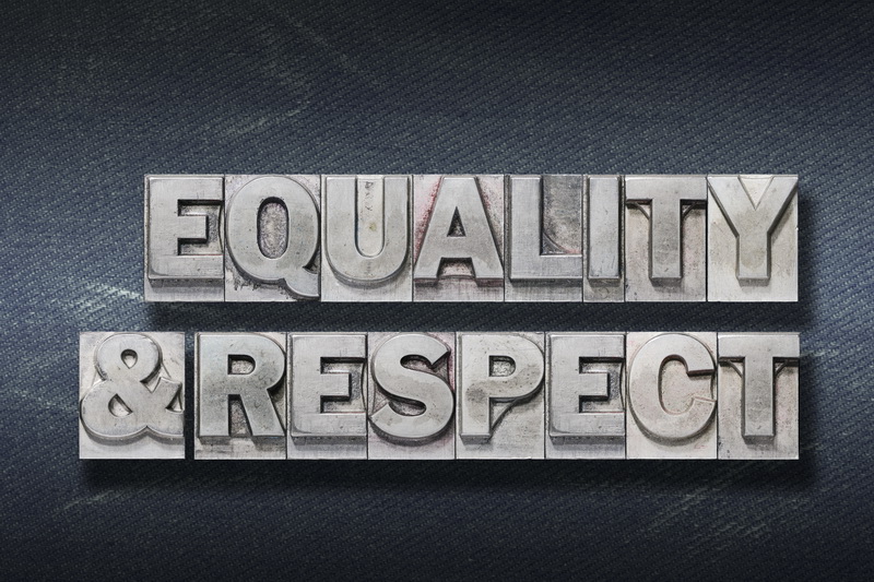 equality and respect words made from metallic letterpress on dark jeans background
